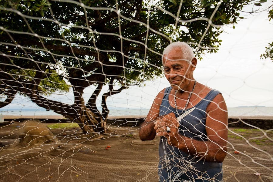 Fisherman fixing a net in Puntarenas, Costa Rica.