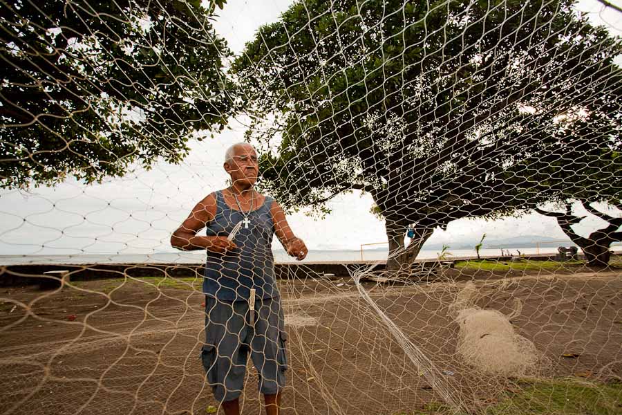 Fisherman mending a net in Costa Rica.