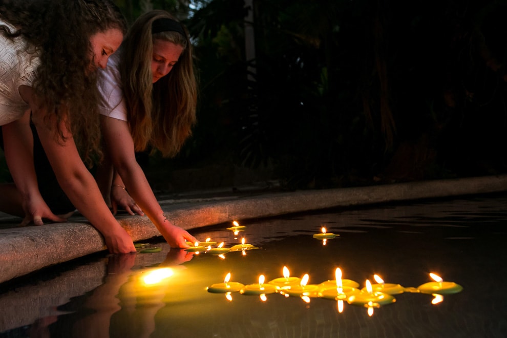 Floating candles in the pool at a villa wedding