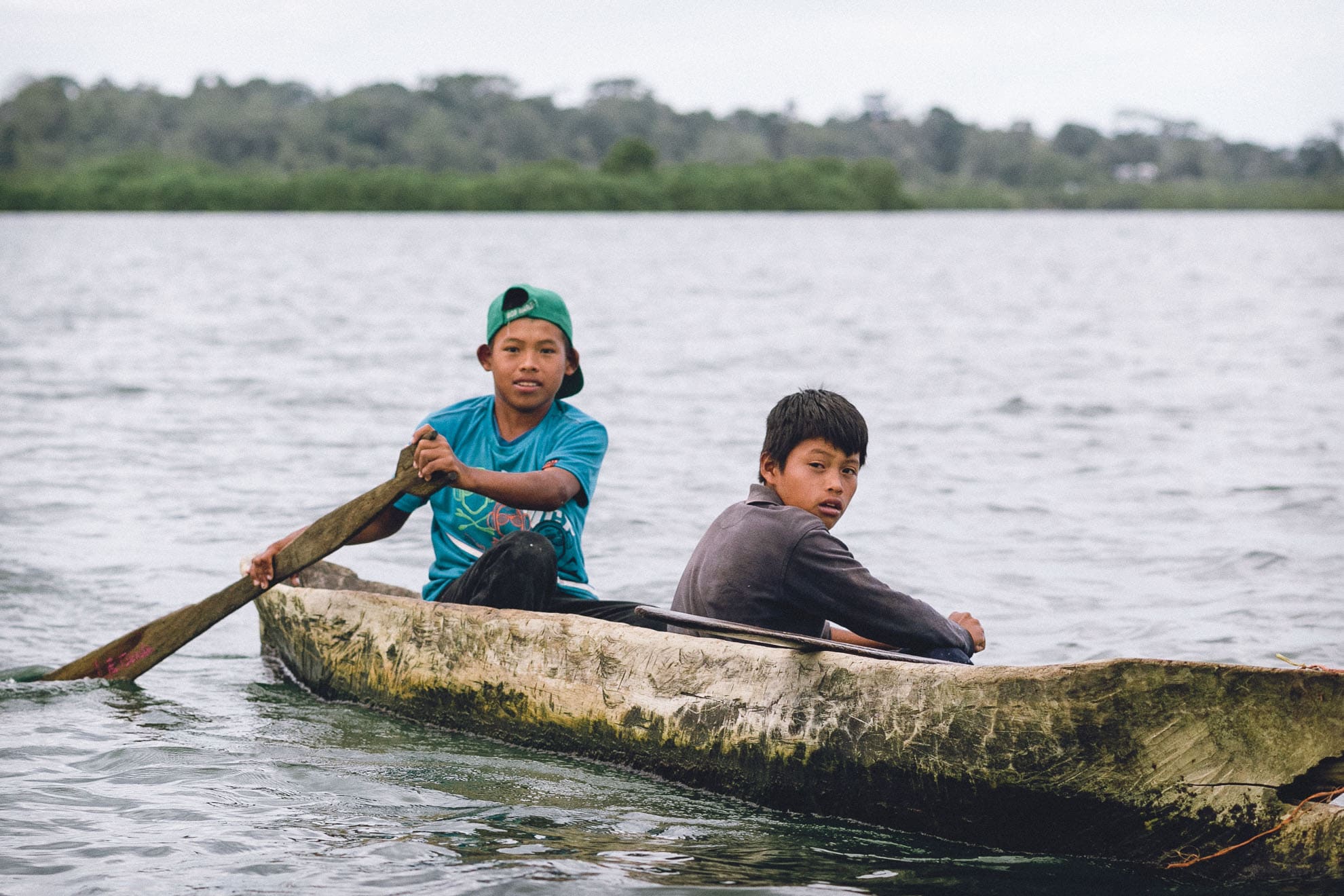Kids fishing dug out canoe in Bocas del Toro
