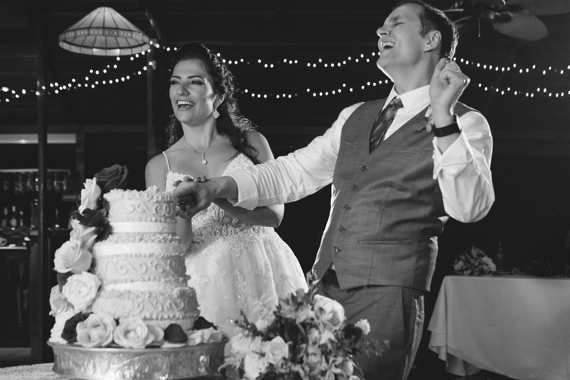 Bride and groom dance as they cut the cake
