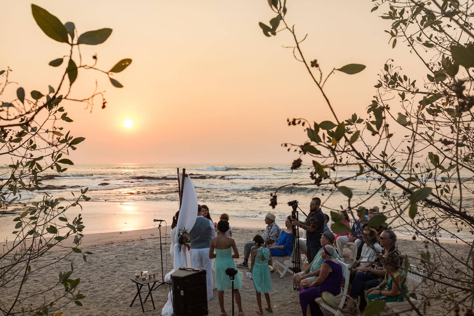 The picturesque ceremony on the beach at sunset.