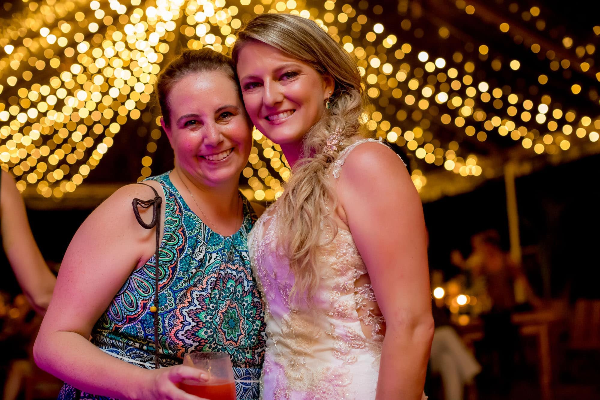 The bride and her friend at the beach wedding reception