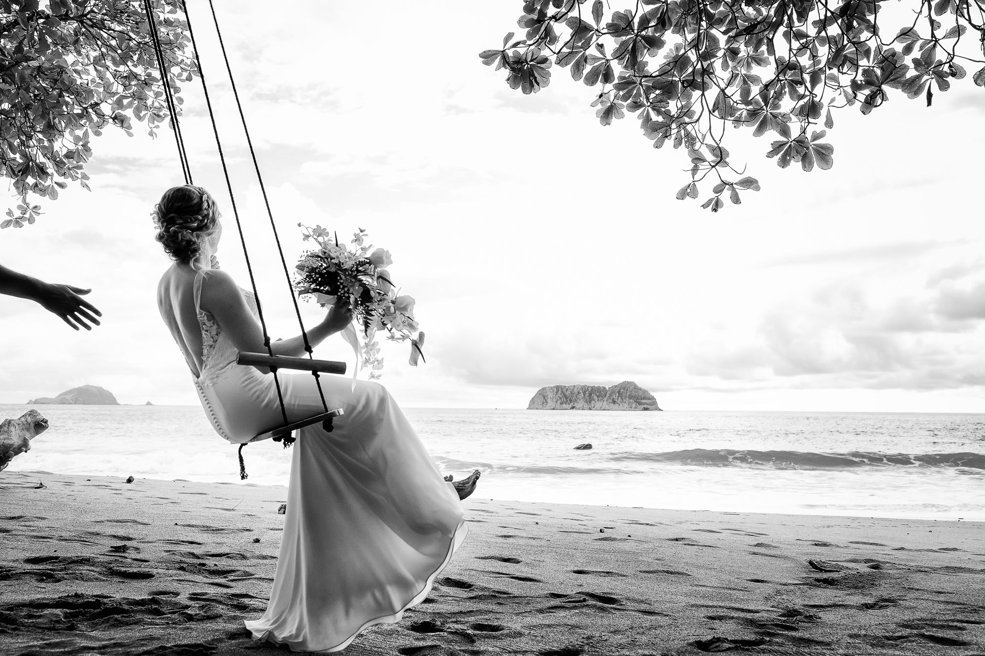 Bride swinging on the beach