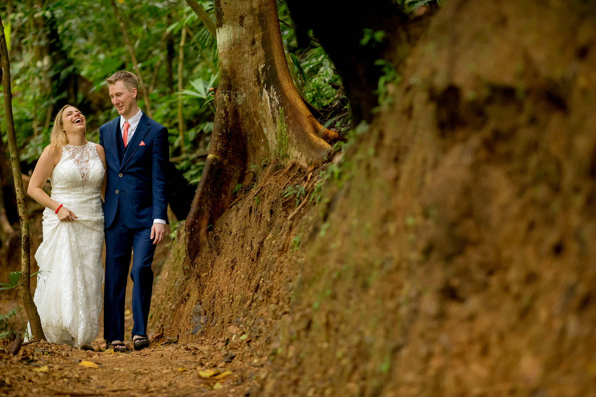 Tromping to the waterfall in their wedding finery