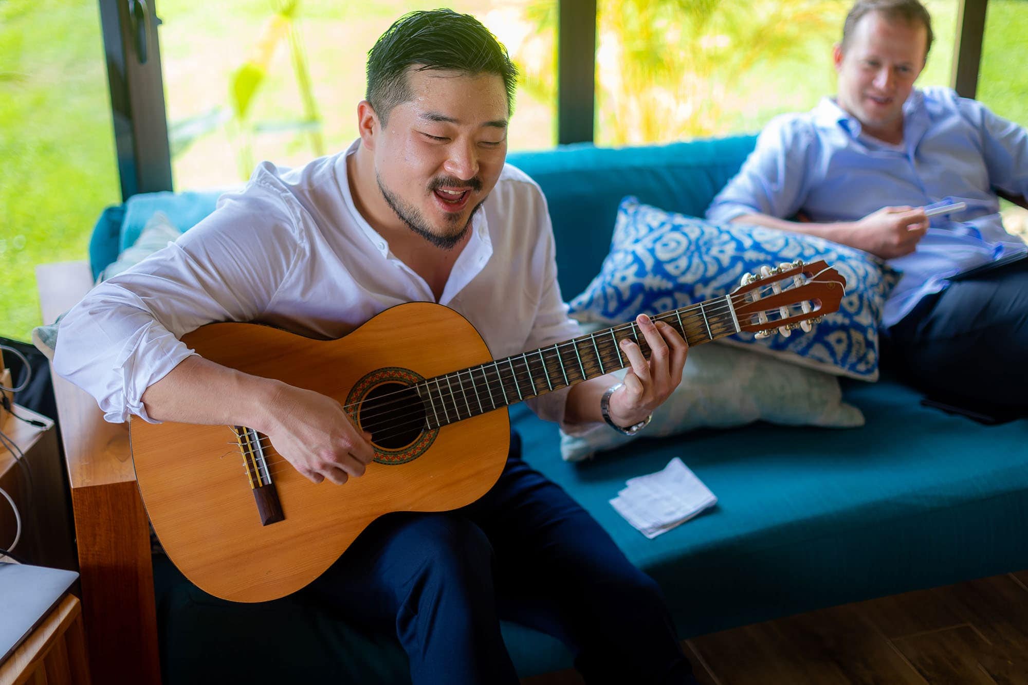 The groom singing with his guitar