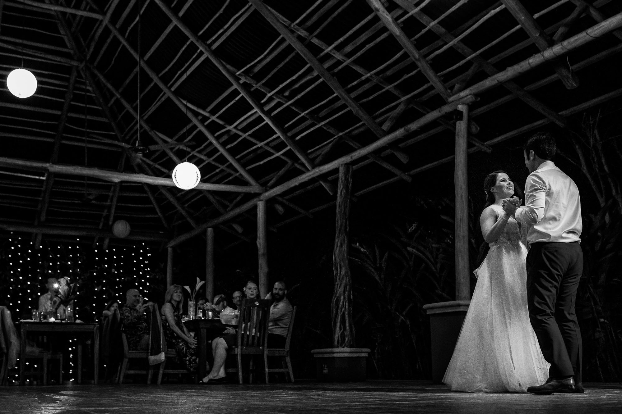 B&W of the bride and groom dancing at the reception